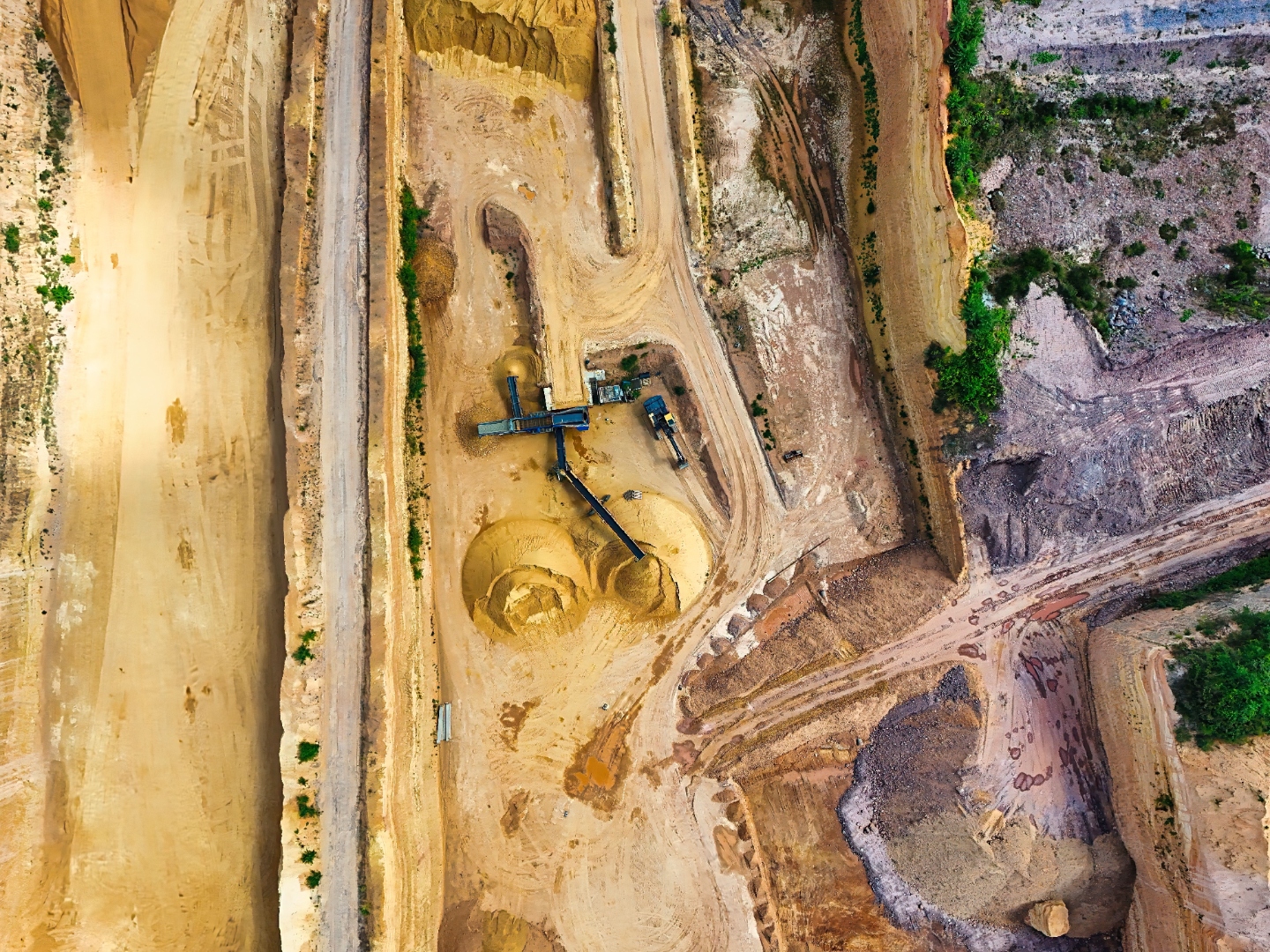 Aerial view of an active mining pit with processing infrastructure and rehabilitation zones — the operational scale behind WA's environmental approval regime
