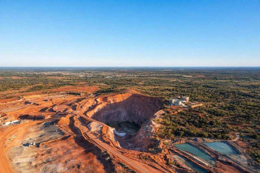 Open-cut mine site in Western Australia — aerial perspective showing access roads and working benches